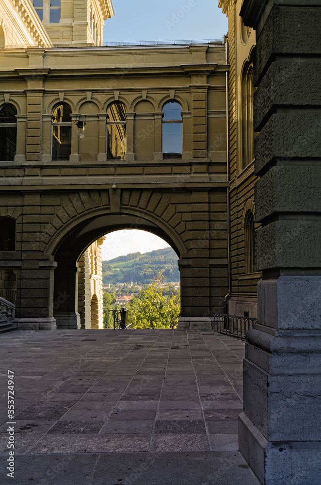 Fototapeta premium Archway in downtown area of Bern, Switzerland, overlooking the river Aare and mountain Gurten. 