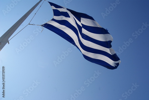 greek flag waving against blue sky