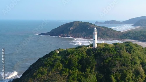 Beatiful lighthouse on the top of a montain of an island with beaches and blue sky 