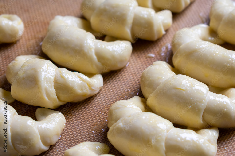 Ready to bake, raw Argentine croissants, medialunas de Manteca over silicon pastry mat Ready to bake, raw Argentine croissants, medialunas de Manteca over silicon pastry mat