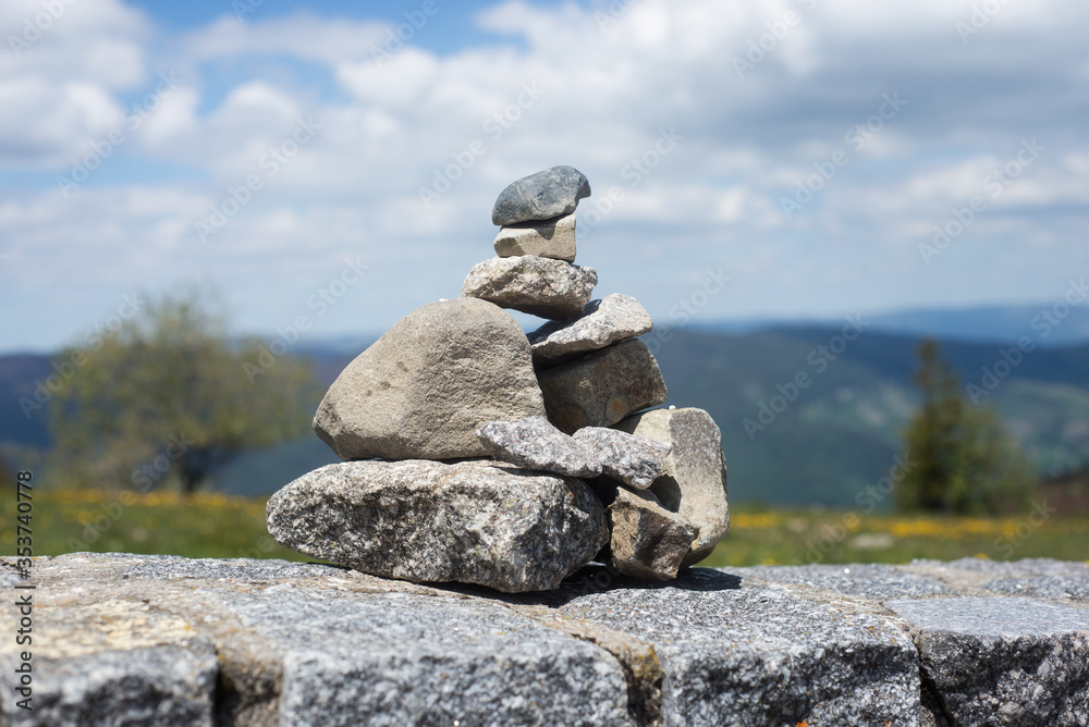 Closeup of stone balance on stoned wall on mountain landscape background Closeup of stone balance on stoned wall on mountain landscape background