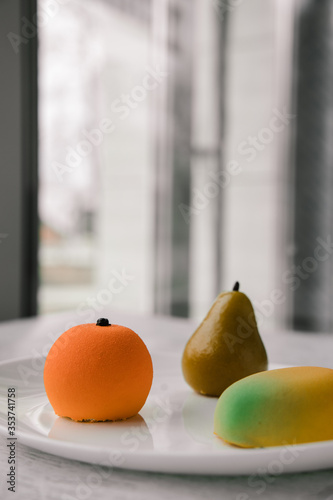 cakes in the form of fruits on a white plate