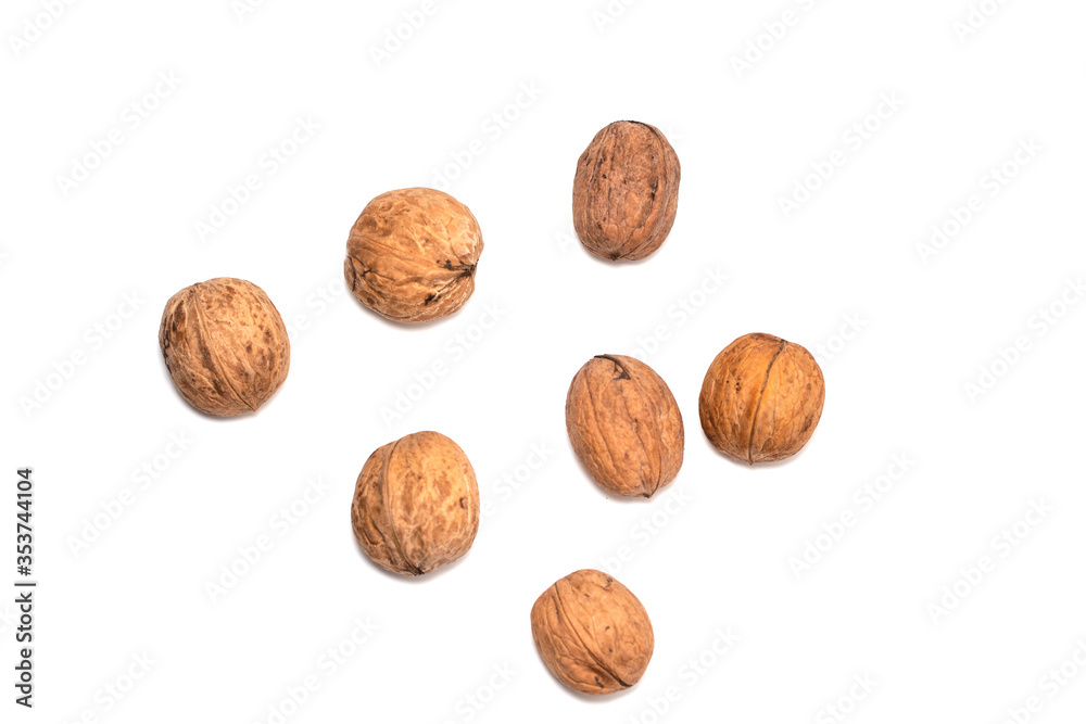 Greek nuts are scattered on a white isolated background. Autumn fruits of trees. Random location Greek nuts are scattered on a white isolated background. Autumn fruits of trees. Random location