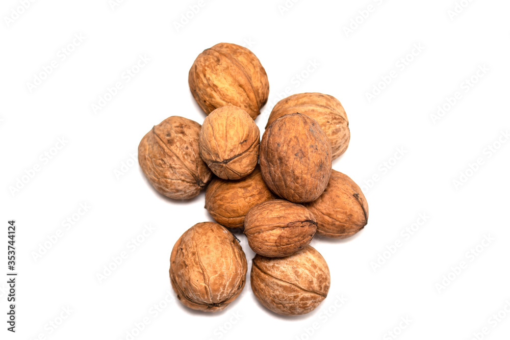 Greek nuts are scattered on a white isolated background. Autumn fruits of trees. Random location Greek nuts are scattered on a white isolated background. Autumn fruits of trees. Random location