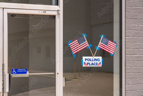 USA flags stuck to window of Polling place for early voting in the USA elections photo