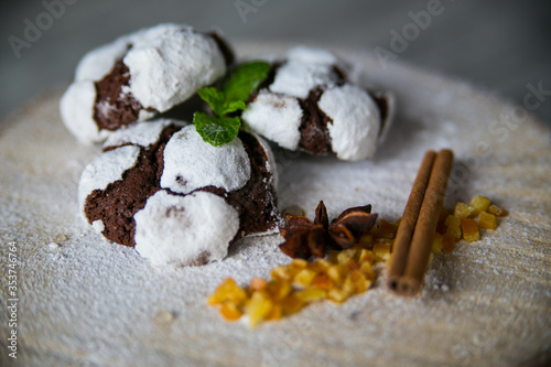  crackle chocolate chip cookies in powdered sugar cinnamon stick, candied fruit on a birch felling