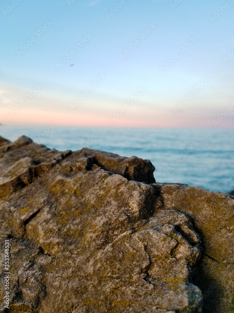 Edge of a rock at lake during a sunset