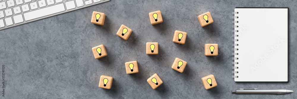 cubes with lightbulb symbols and a keyboard on concrete background cubes with lightbulb symbols and a keyboard on concrete background