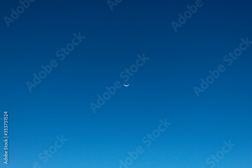 Stunning sunset Waning creacent moon at blue hour with no clouds sky. 