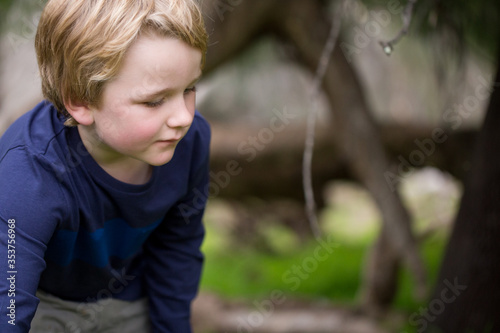 Little blonde boy exploring in nature with copy space © Caseyjadew