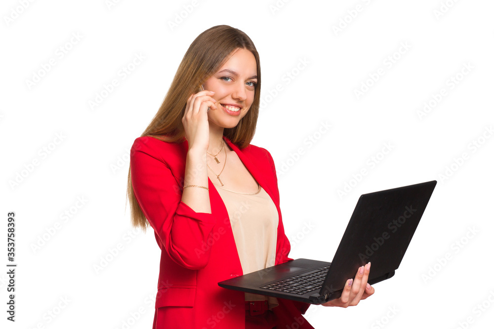 office woman looking at camera smiling, Holding a laptop and talking on the phone.