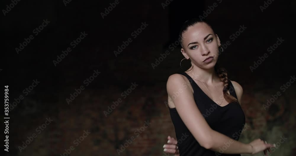 Passionate girl looking strongly into camera and dancing freestyle in terrain