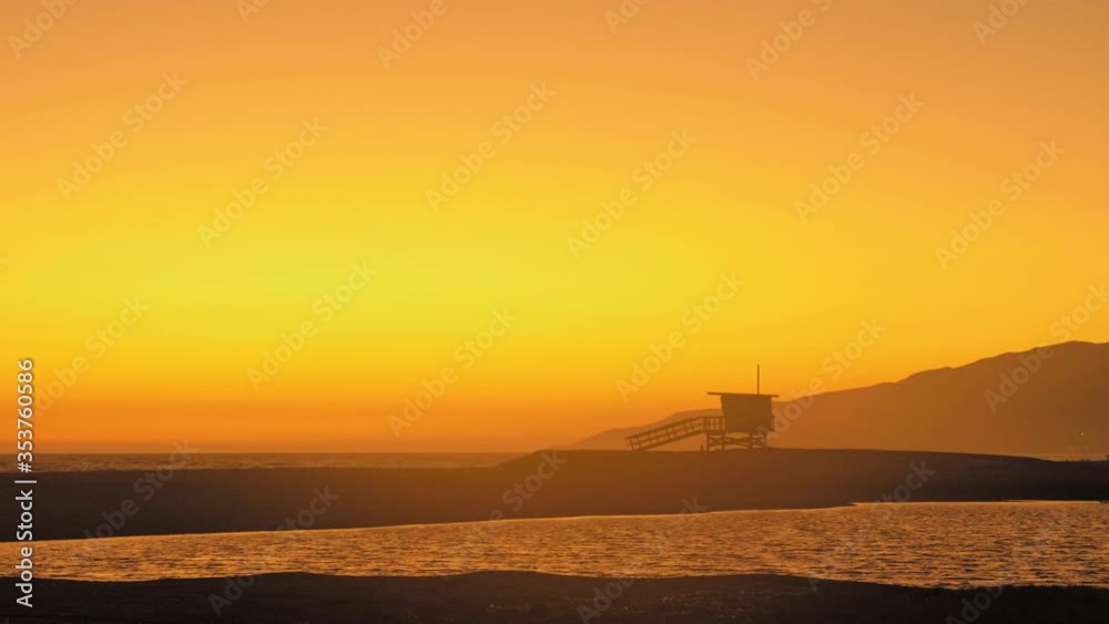 sunset on a bright orange malibu beach with red tints. against the background of the sea sunrise morning summer sunny dry handheld shot sunset on a bright orange malibu beach with red tints. against the background of the sea sunrise morning summer sunny dry handheld shot