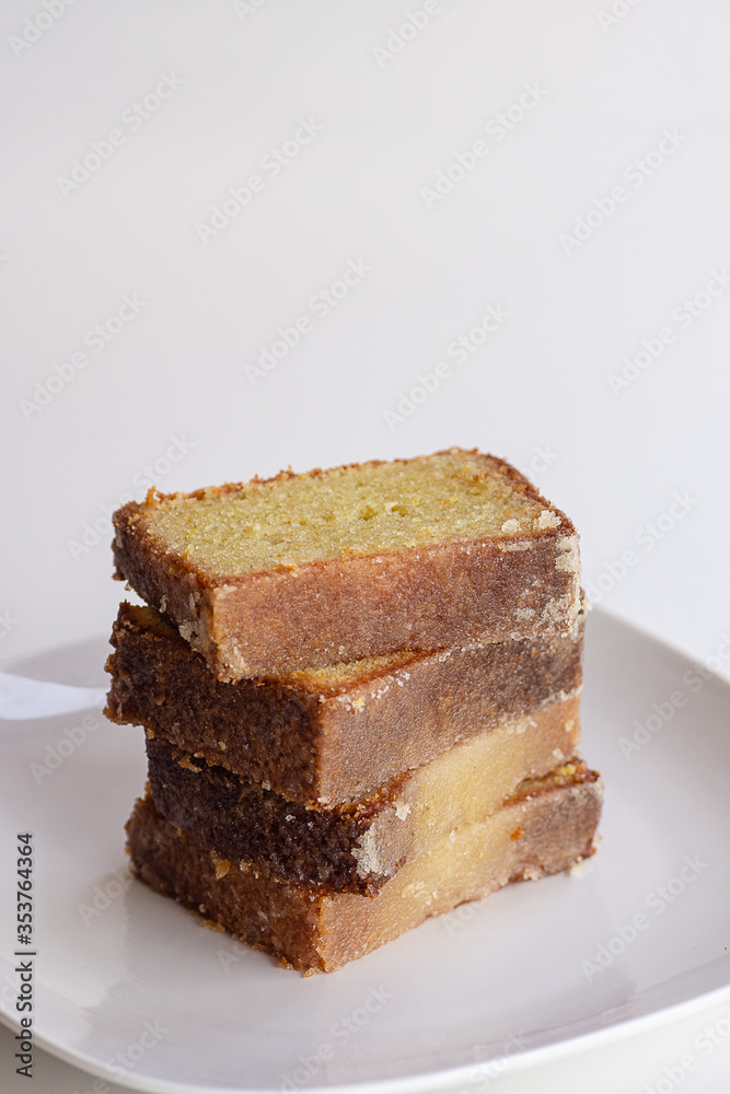 Stack Of Sweet Lemon Dessert Bread Slices On White Plate With White Background Stack Of Sweet Lemon Dessert Bread Slices On White Plate With White Background