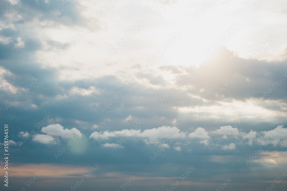 Obraz premium Sunset sunrise and beautiful twilight fluffy storm cloudy blue and yellow sky smoothly flowing to fantastic mind. Rainy good evening and have a nice day concept.