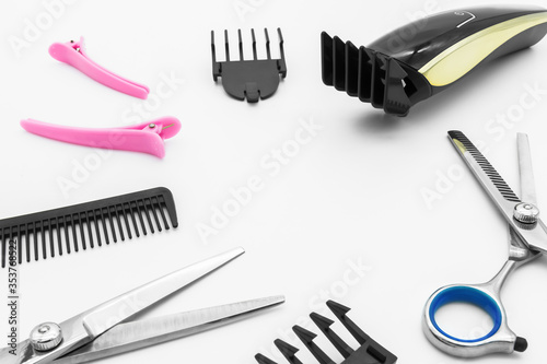 Hair scissors set hairdressing tools with cordless electric hair clipper are isolated on white background.