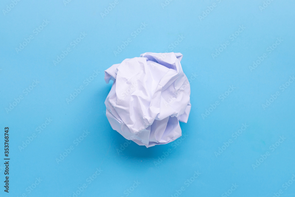 Crumpled paper ball on blue background. Crumpled paper ball on blue background.