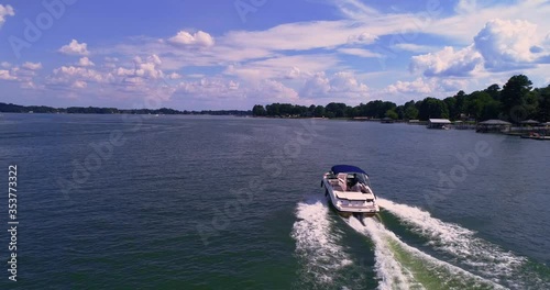 Speed boating on sunny day, aerial drone shot, Lake Norman, NC