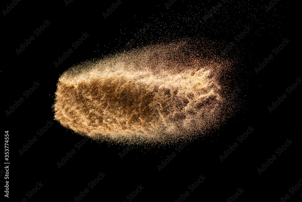 Fototapeta premium Dry river sand explosion.Brown color sand splash against black background.