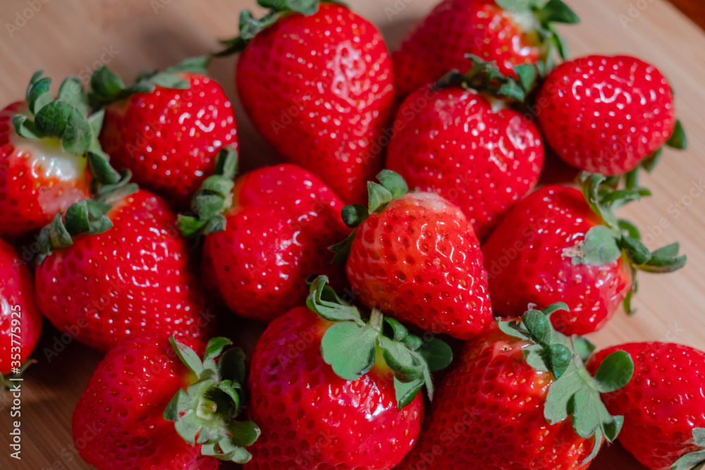 Fresh red strawberries on a wooden board Fresh red strawberries on a wooden board