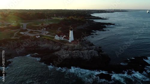 Aerial footage of the New England coastline and lighthouse in fall photo