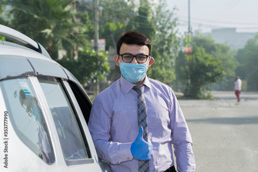 Businessman wearing hygienic face mask and giving thumbs up to protect from Virus