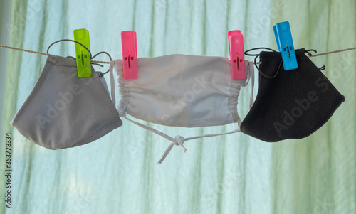 reusable medical mask after washing hanging on a clothesline.