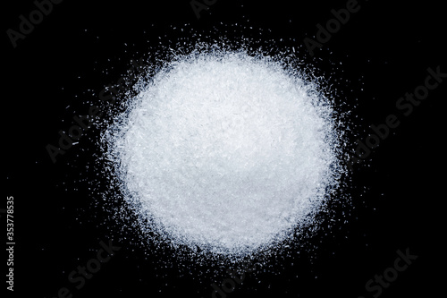 Pile of Monosodium glutamate ( MSG ) isolated on dark background. Top view. Flat lay.