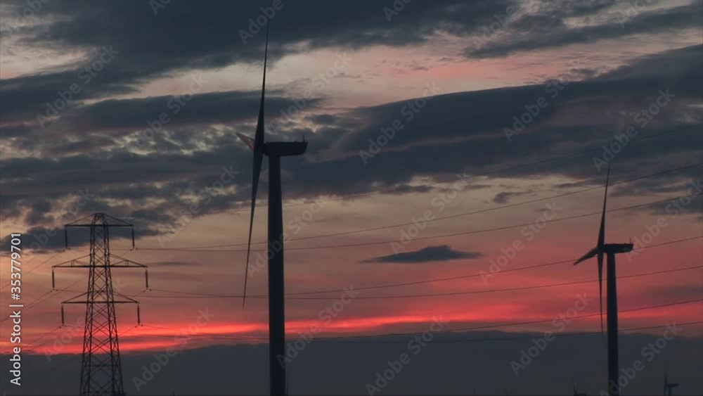 Wind turbines with pylons in the evening sunset Manchester Wind turbines with pylons in the evening sunset Manchester