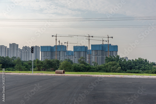 Asphalt road and perspective view of urban real estate development building