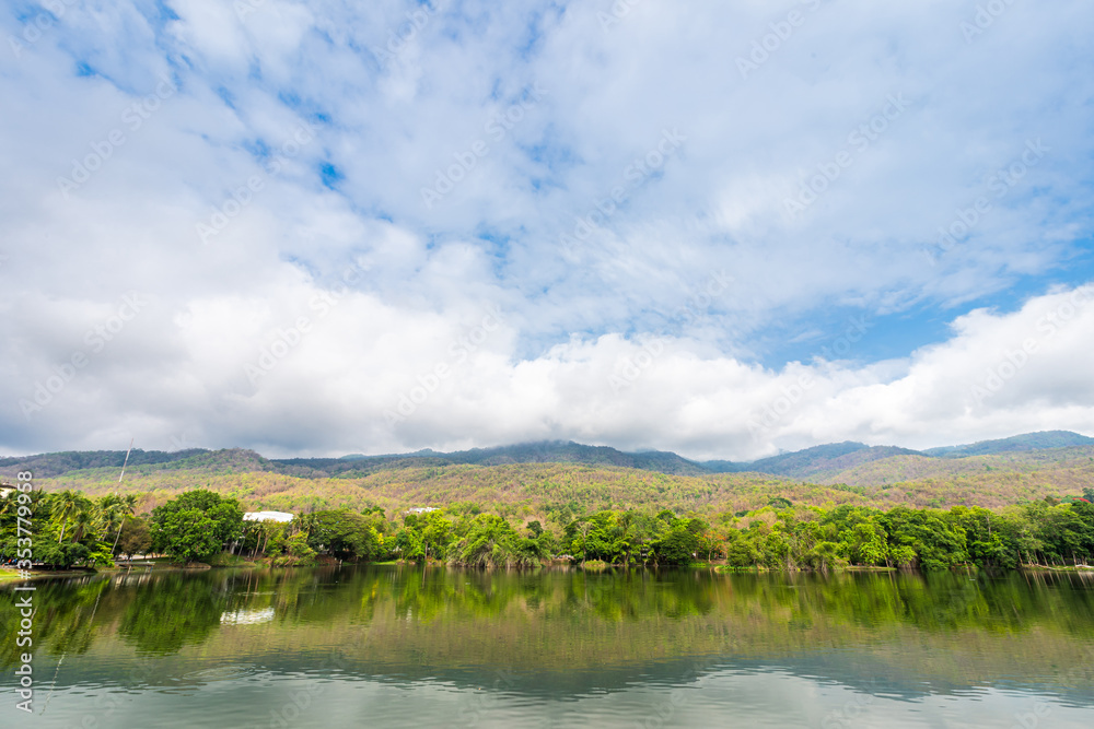 Fototapeta premium landscape lake views at Ang Kaew Chiang Mai University in nature forest Mountain views spring blue sky background with white cloud.