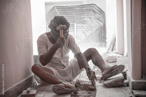  jaipur. Rajasthan. India - may 21, 2020 Asia people work hard about construction in factory with wearing mask (covid19 )