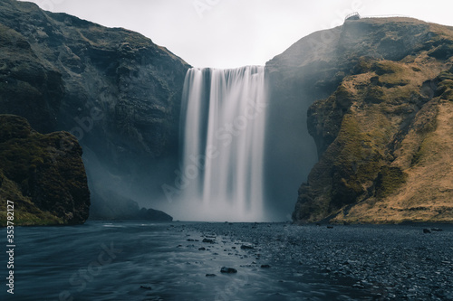 Fototapeta Naklejka Na Ścianę i Meble -  A long exposure photo of Icelandic waterfall called Skogafoss during the COVID outbreak without people
