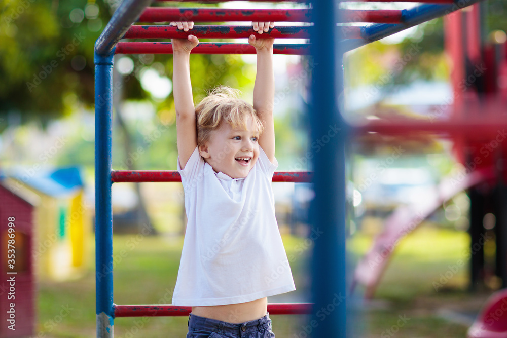 Child on playground. Kids play outdoor.