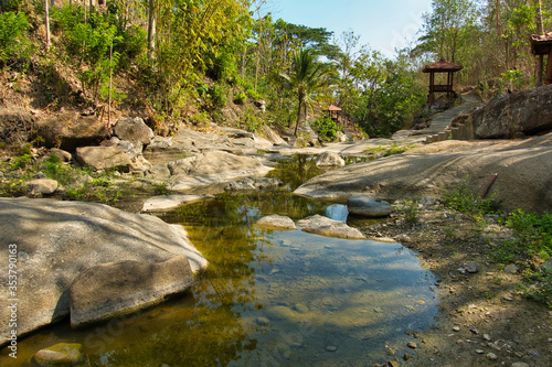 Beautiful view, close up of a karst rock raising from the river. Luweng Sampang Special Region of Yogyakarta. Indonesia