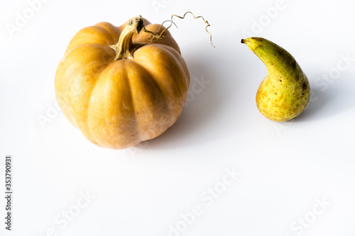 Top view of autumn fruits pumpkin and pear