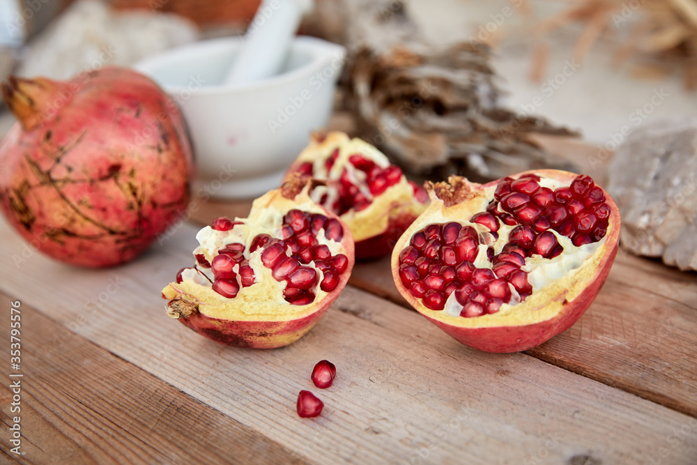 ripe organic pomegranate on teh wooden background ripe organic pomegranate on teh wooden background