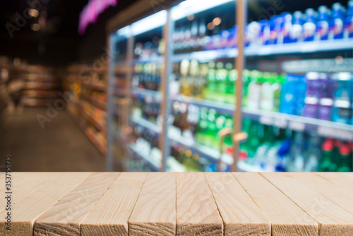 Wood top table on blur supermarket background