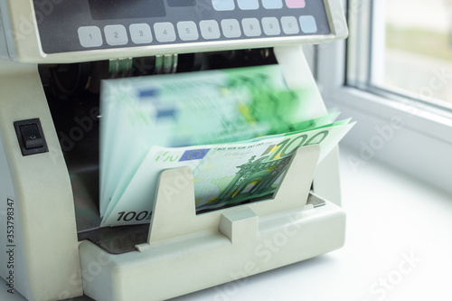 Euro EUR banknotes of 100 on money counter machine. Automatic money counting in the machine