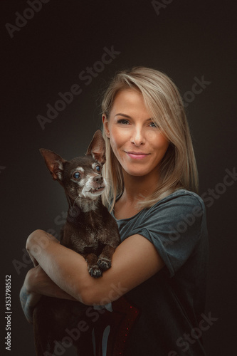 Young pretty woman with her Toy Terrier dog
