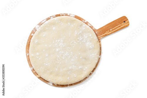 Slika na platnu Fresh raw dough for pizza or bread baking on wooden cutting board isolated on white background