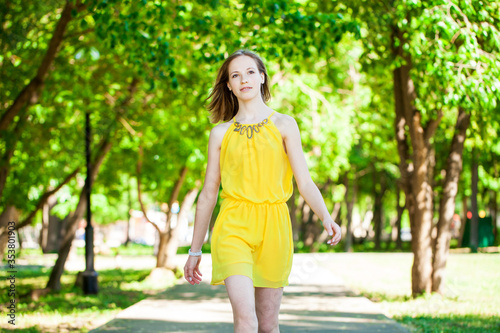 Portrait of a young beautiful blonde girl in yellow dress