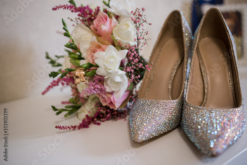 wedding gold rings with bride shoes and decor