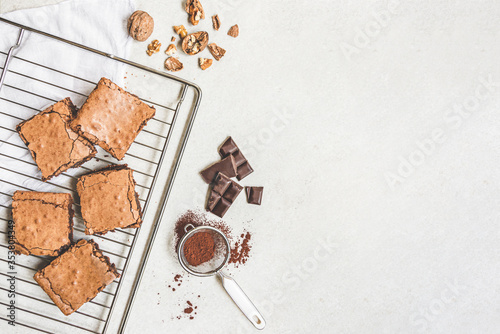 Obraz na płótnie Top view of freshly baked home made brownie cake arranged with recipe ingredients over white rustic background. Copy space. w salonie