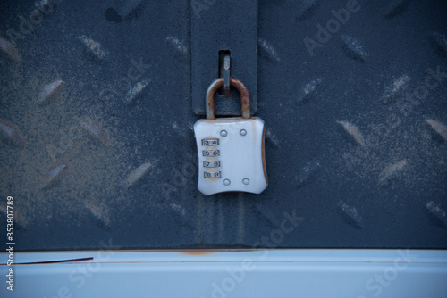 rusty combination padlock in blue metallic box