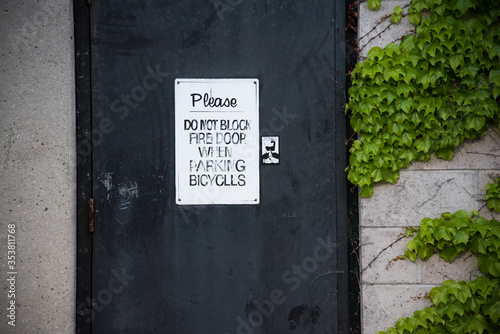 Metallic exit door with sign and ivy