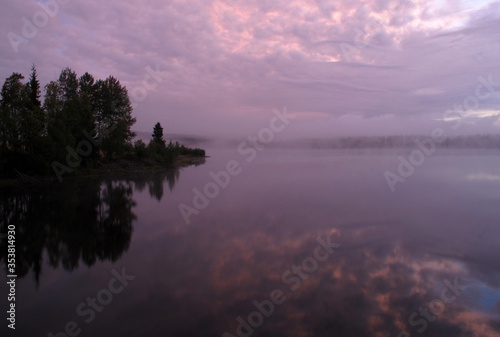 reflection of trees in water early morning in southern Norway