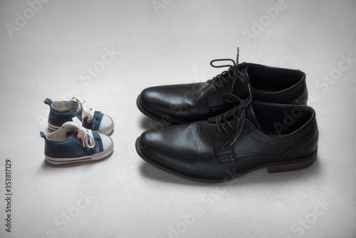 Adult and Child, age concept, baby and adult shoes 