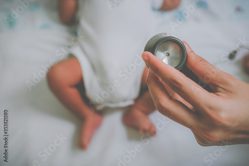 The doctor holds the stethoscopes to health check the baby. Baby health check concept.