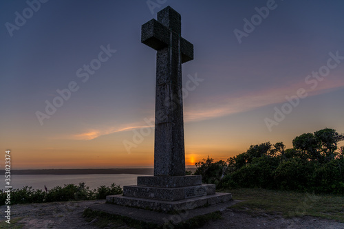 Sunset behind the cross at Dodman Point, Cornwall in late Spring photo